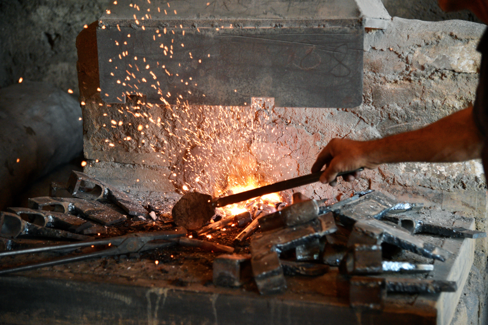 building,cooking,food,man,kitchen,oven,table,grill,pan,standing,hot,large,counter,pizza,stove,woman,dog,dirty,eating,holding,street
