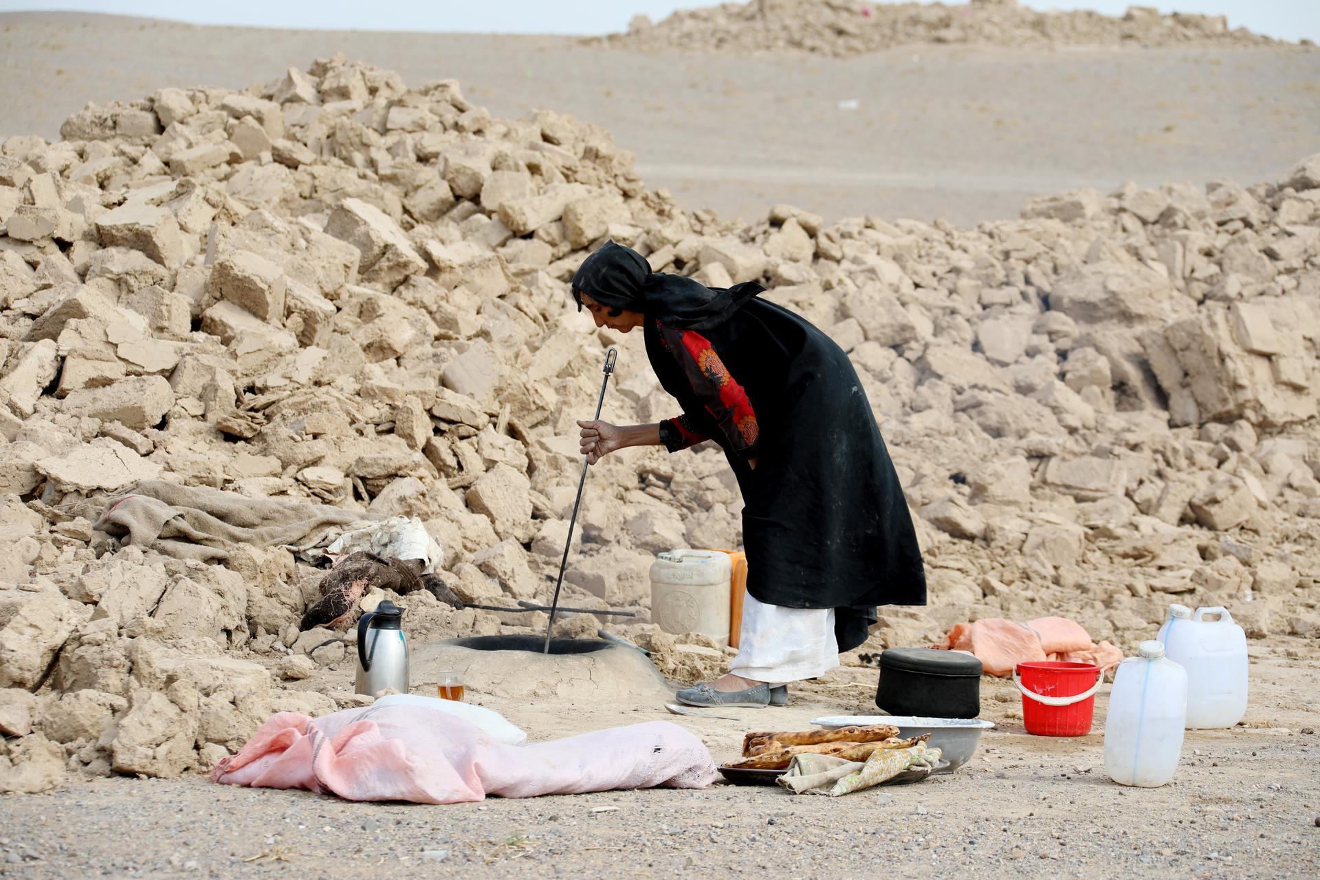 a person sitting on top of a sandy beach