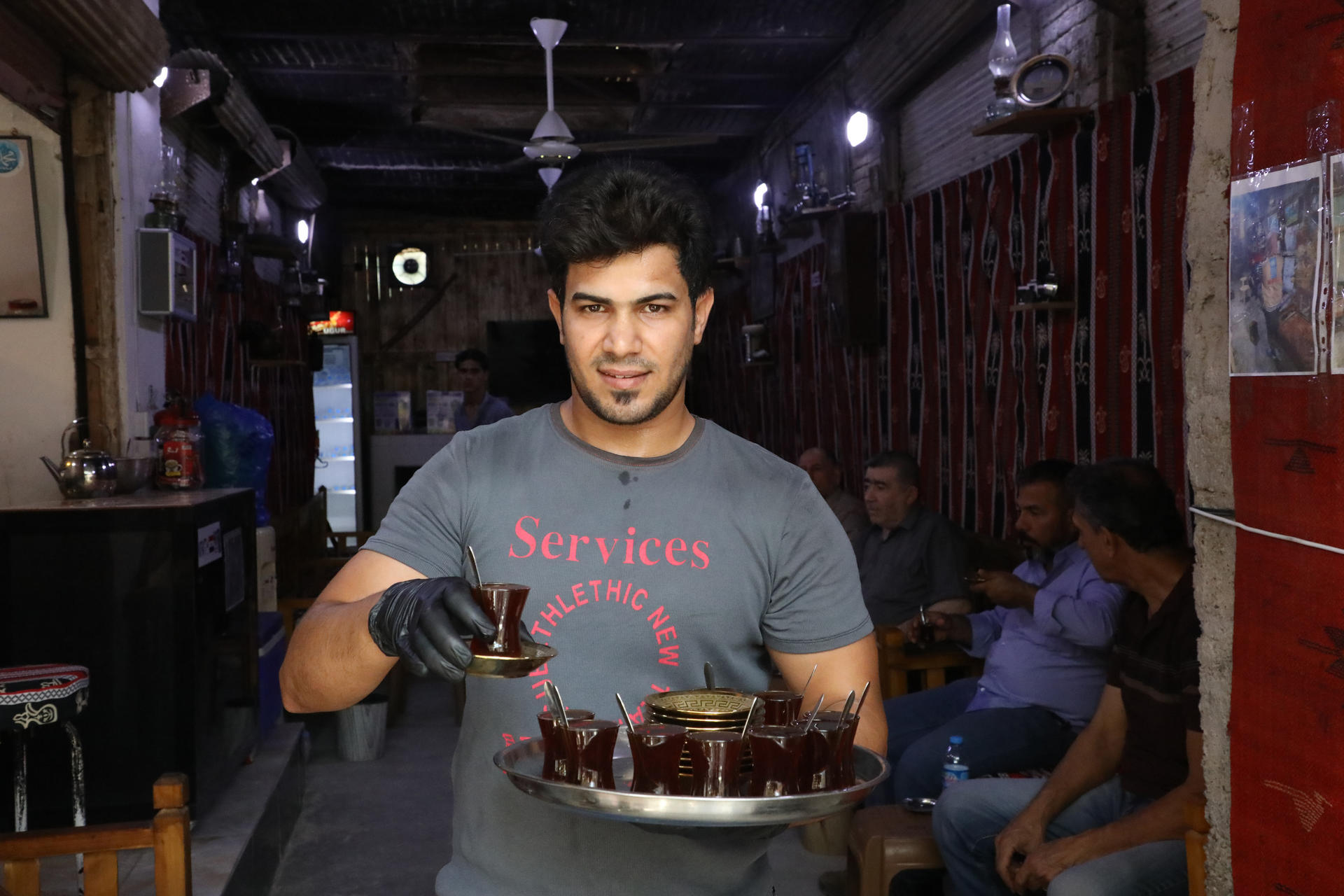 a man standing in front of a restaurant