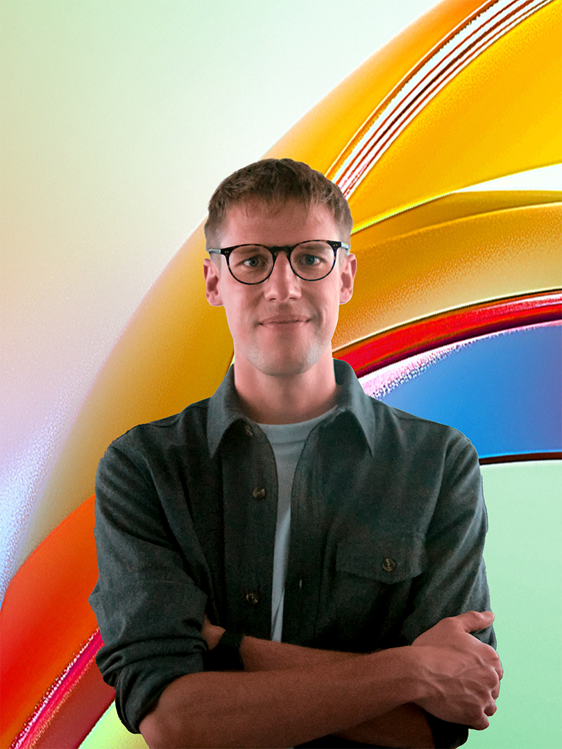 a man with glasses looking at the camera
