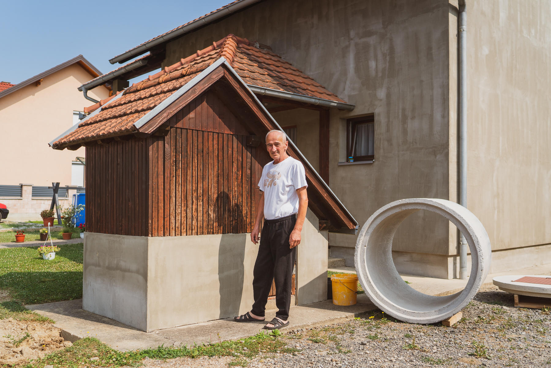 a man standing in front of a house