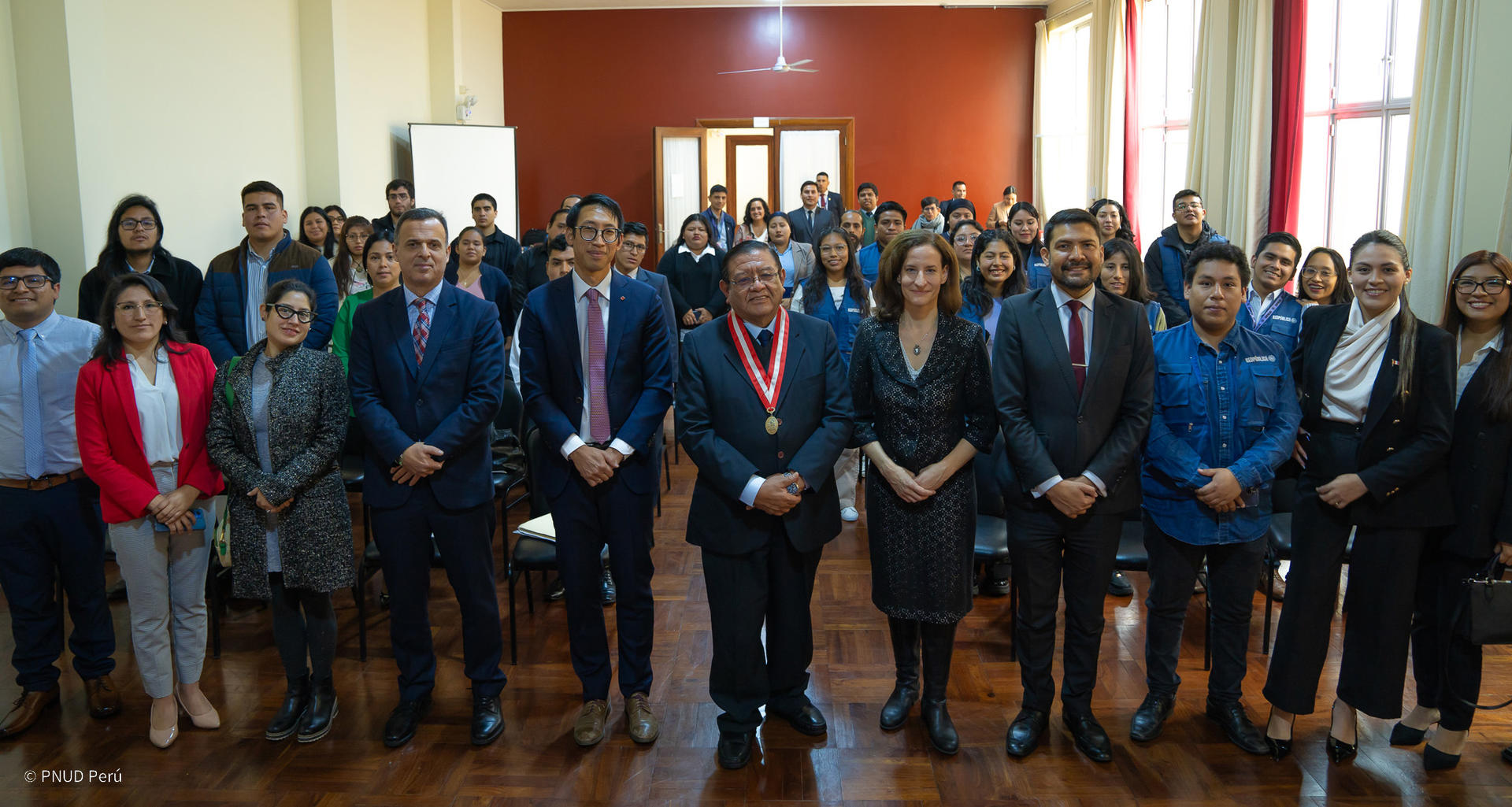 a group of people standing in front of a crowd posing for the camera