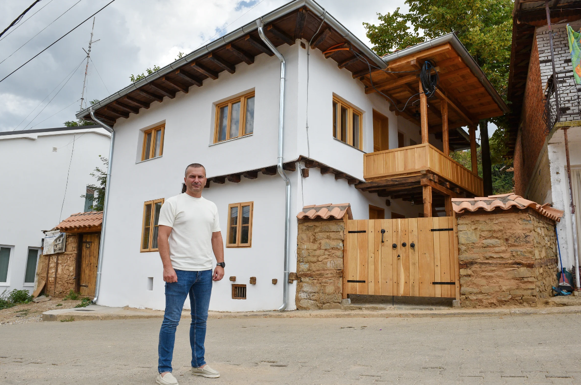 a man standing in front of a house