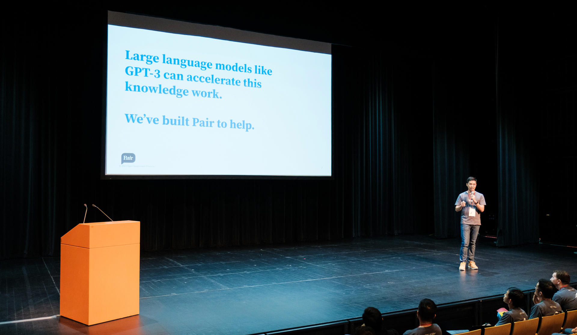 A person on a stage presenting about Pair