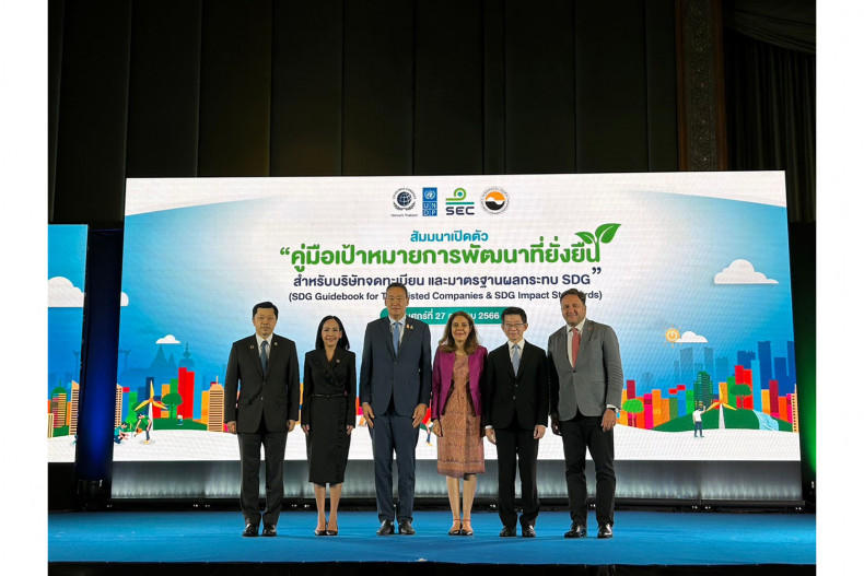 a group of people standing in front of a screen