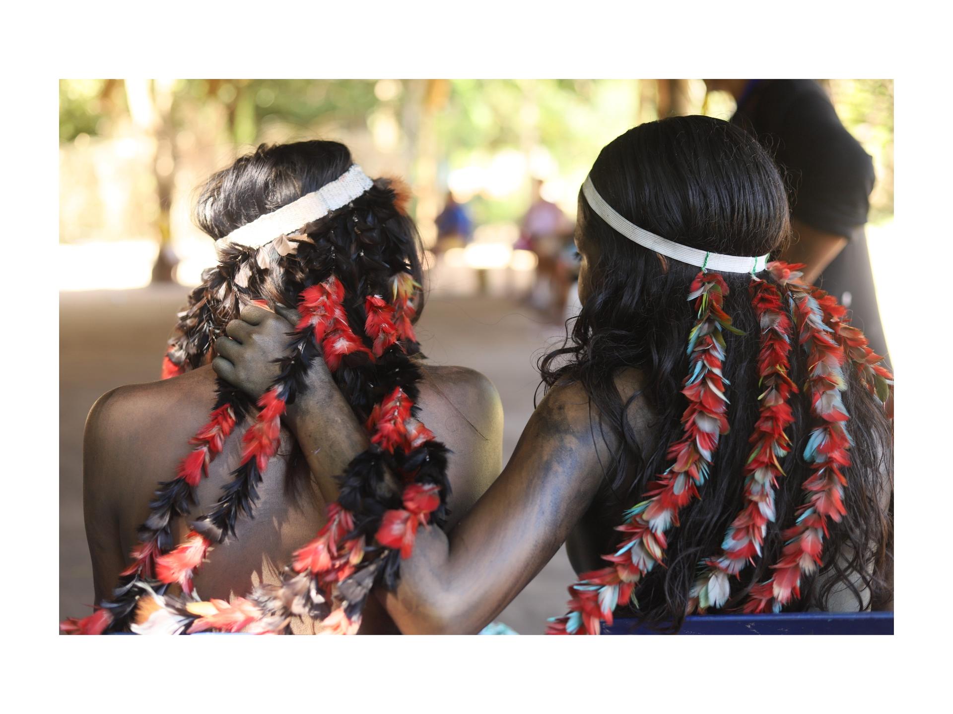 Two Amazonian women wearing traditional headdresses 