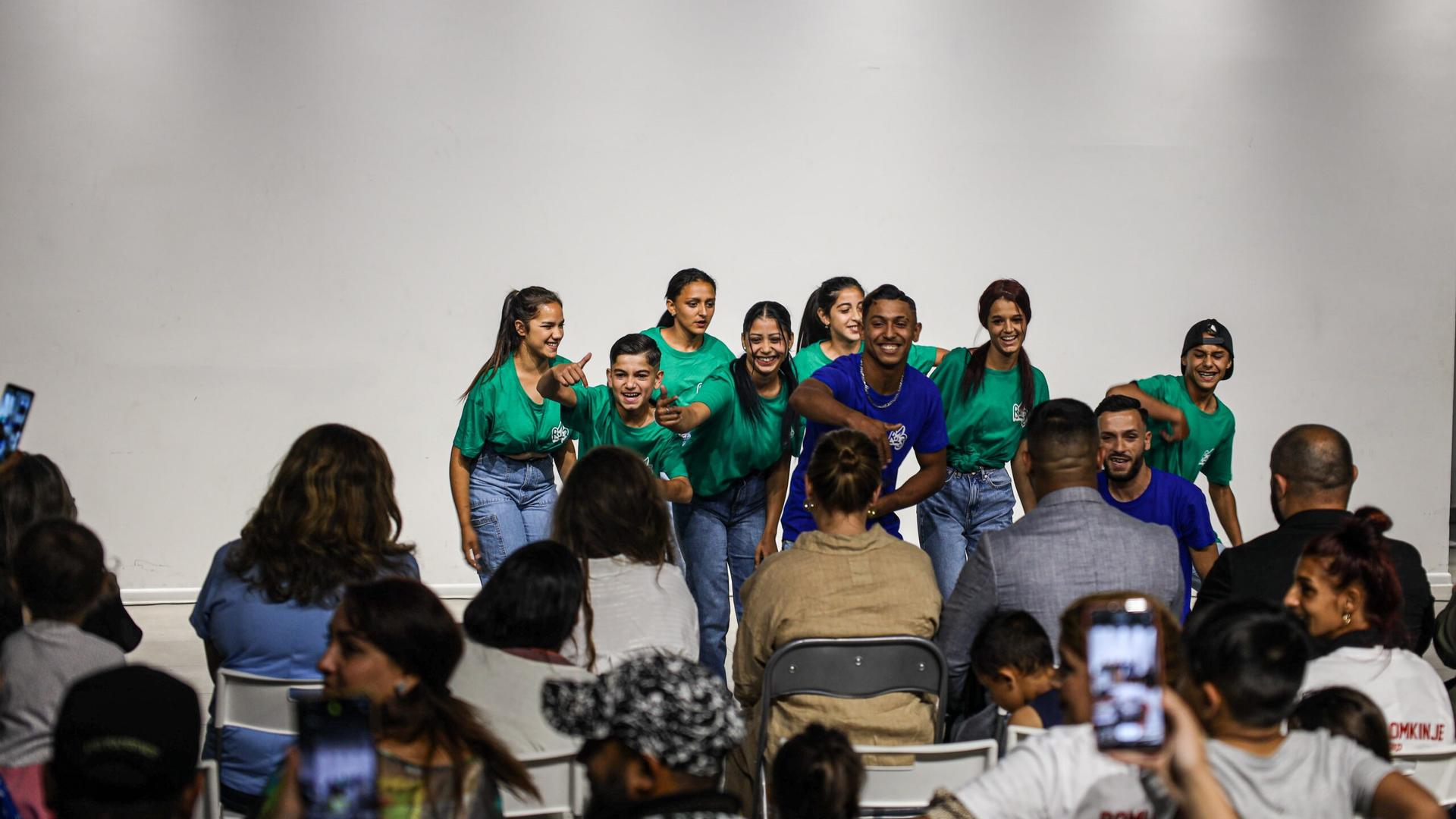 a group of people standing in front of a crowd