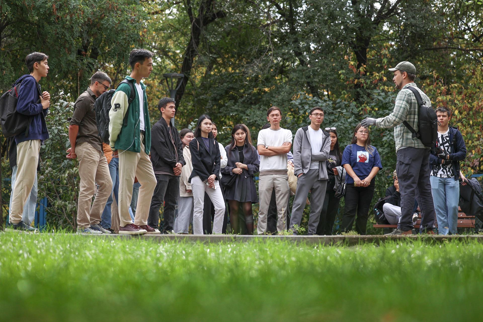 a group of people that are standing in the grass