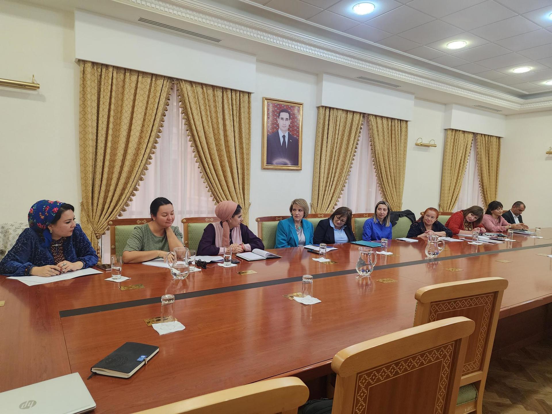 a group of people sitting at a table in a room