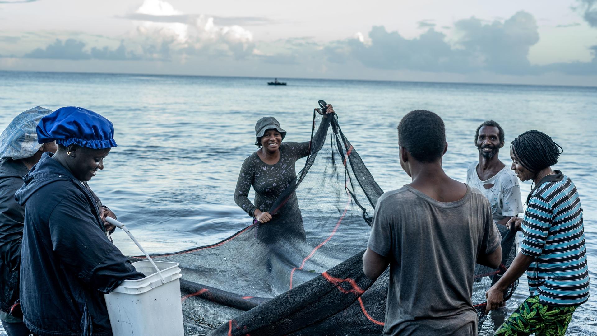fishers with nets in the ocean