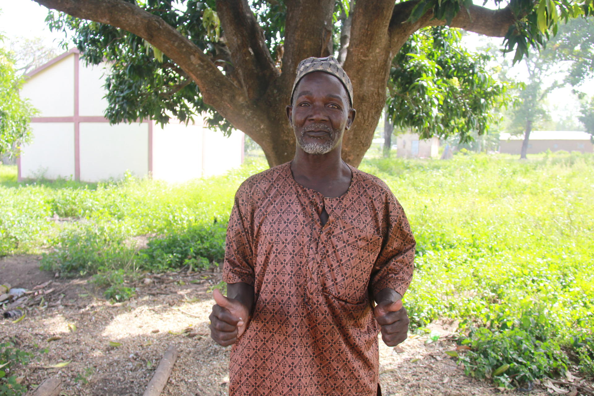 a man standing in front of a tree