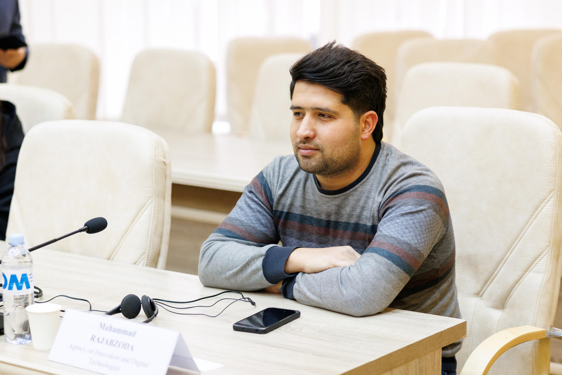 a man sitting at a table using a laptop