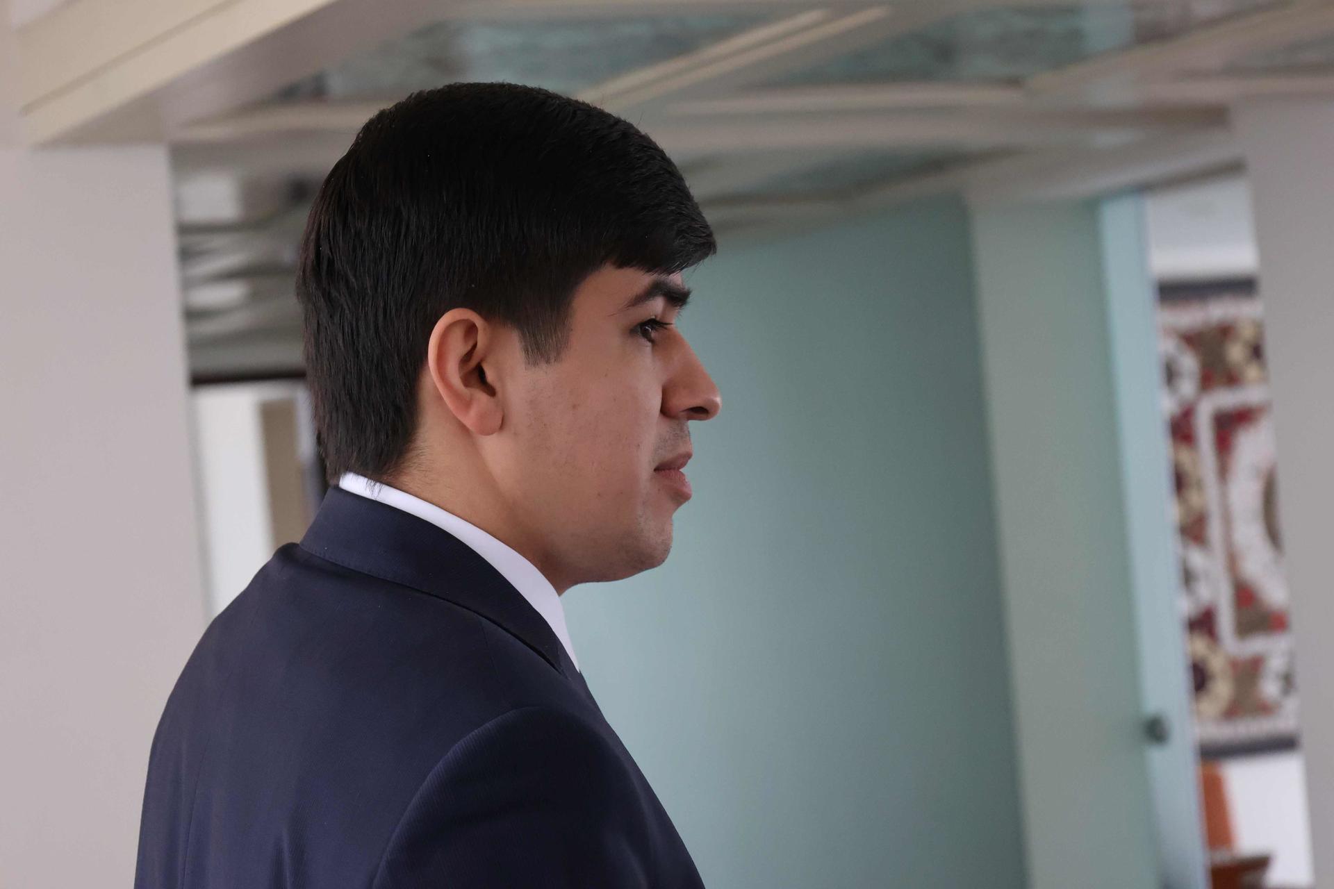 a man wearing a suit and tie looking at the camera
