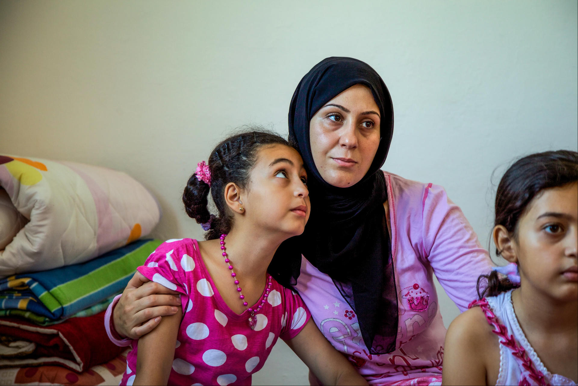 Woman in hijab with two young girls