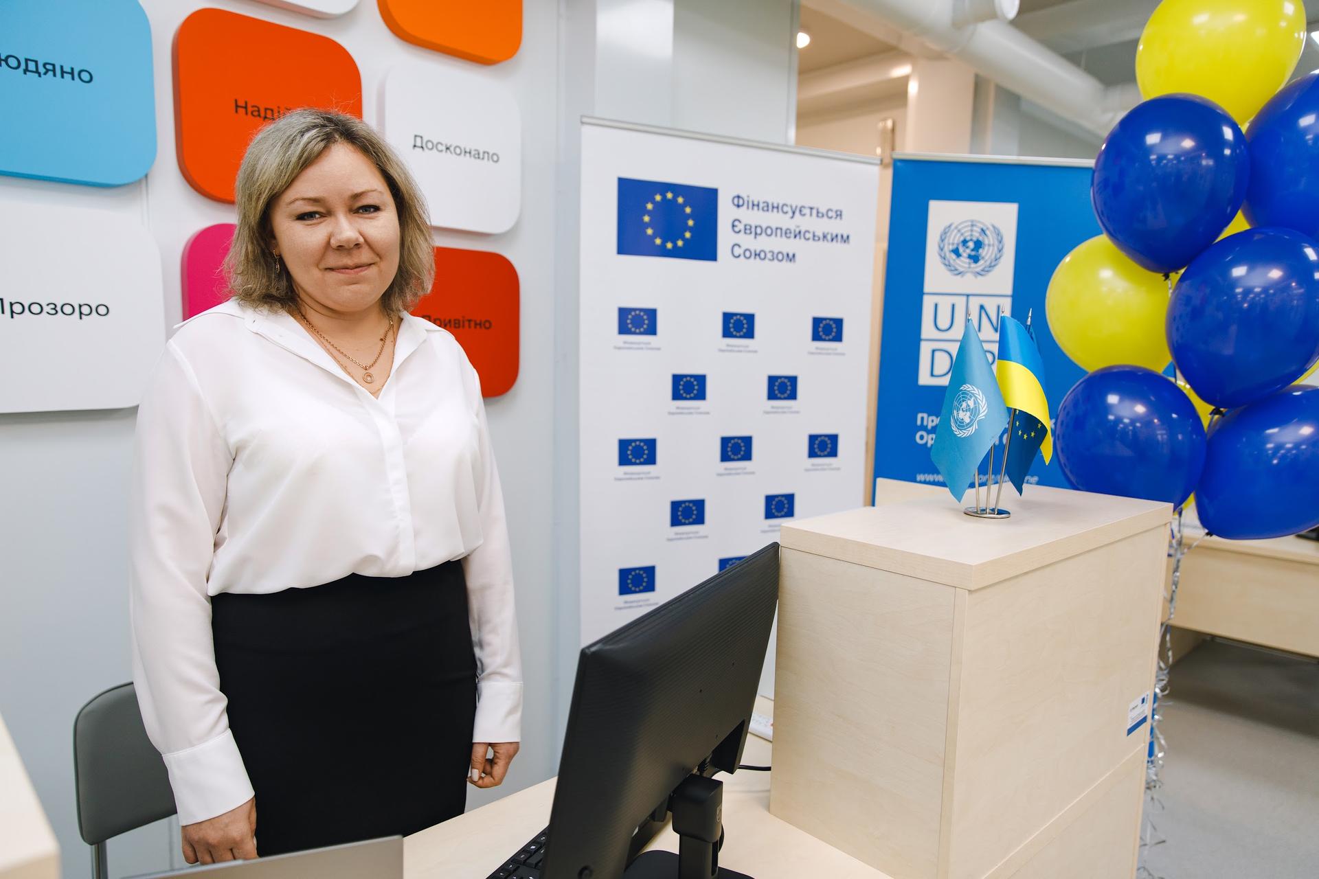 a woman standing in front of a box posing for the camera