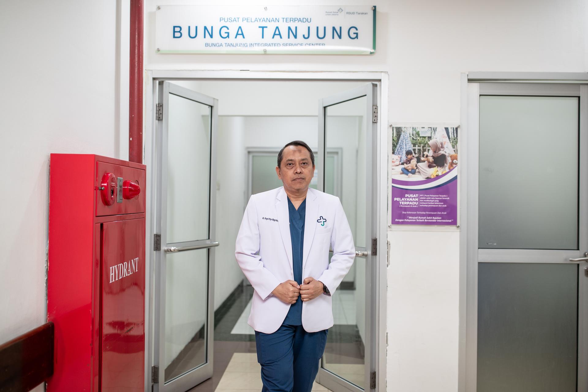 a man standing in front of a refrigerator