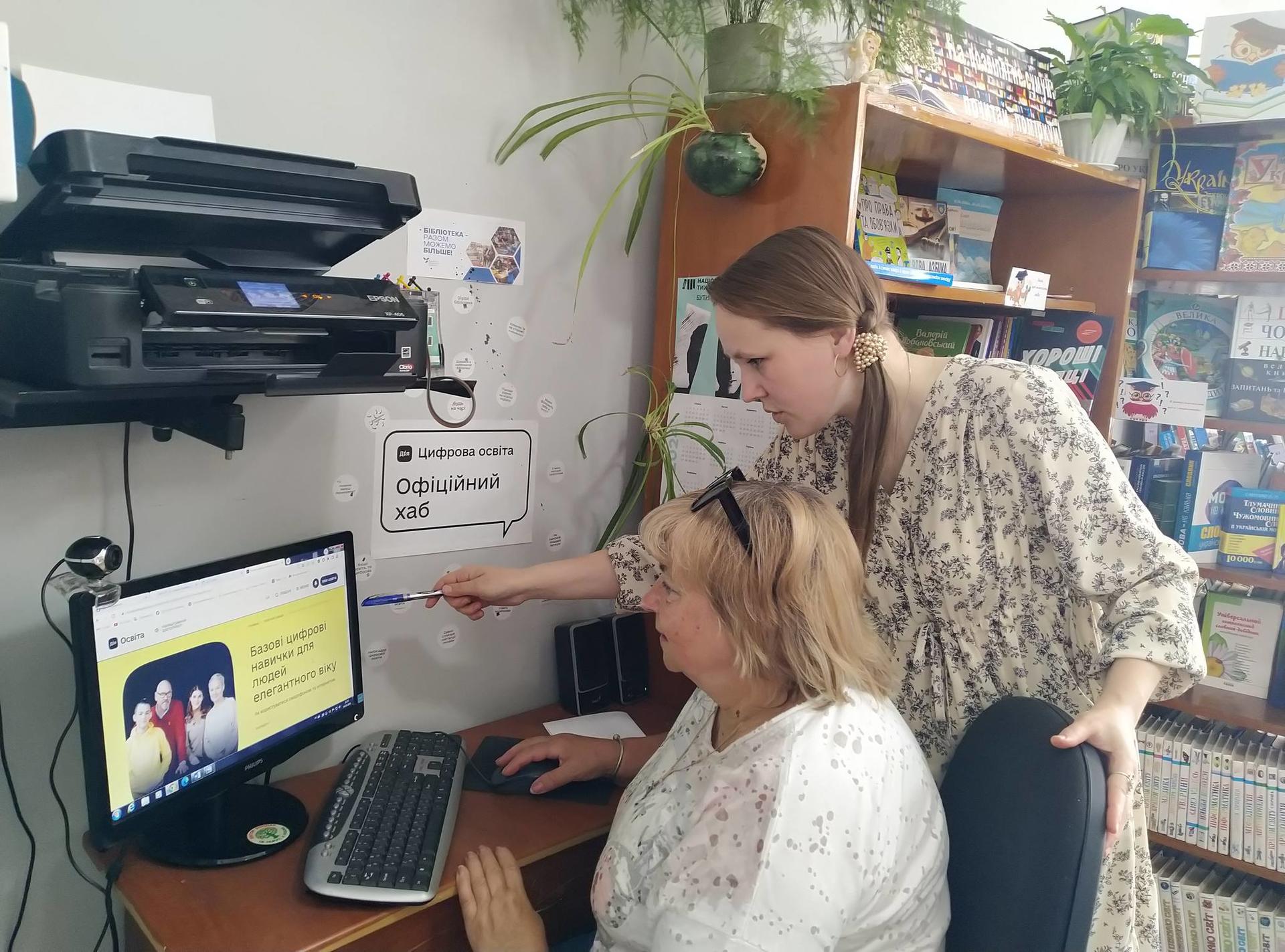 a person using a laptop computer sitting on top of a table