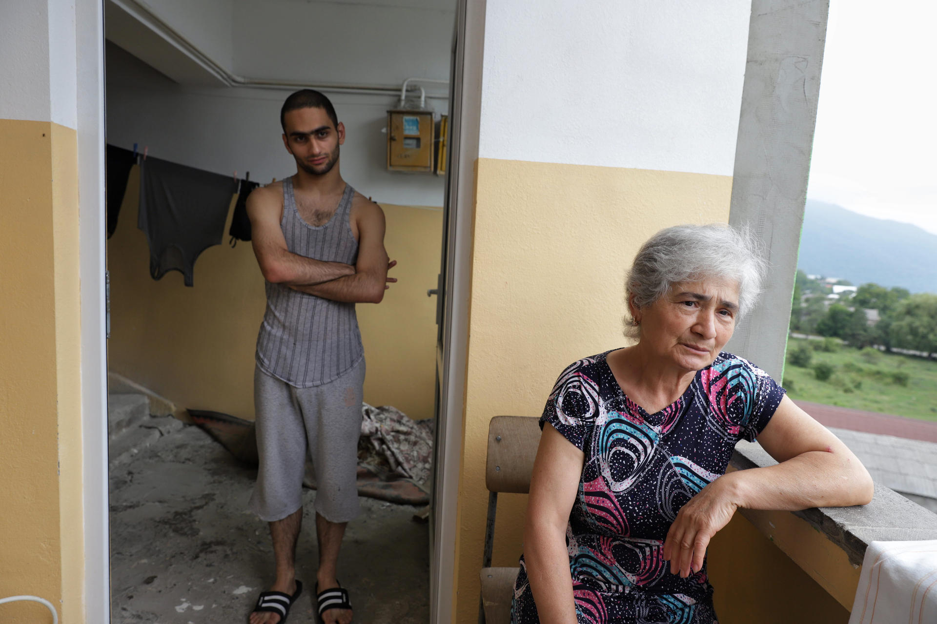 a man and a woman looking at the camera