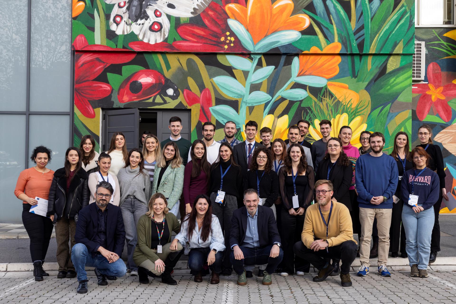 a group of people standing in front of a crowd posing for the camera