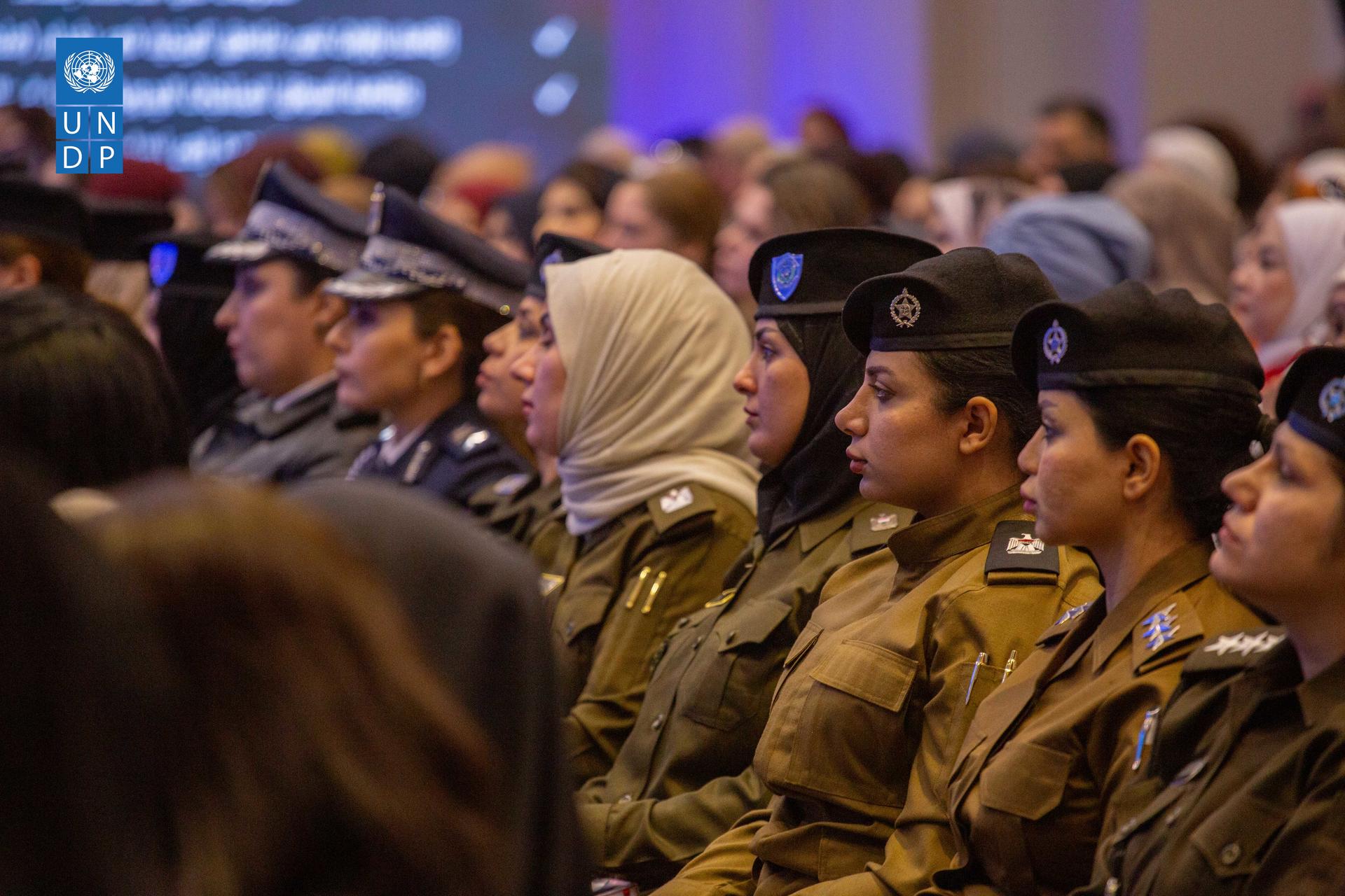 a group of people in uniform standing in front of a crowd