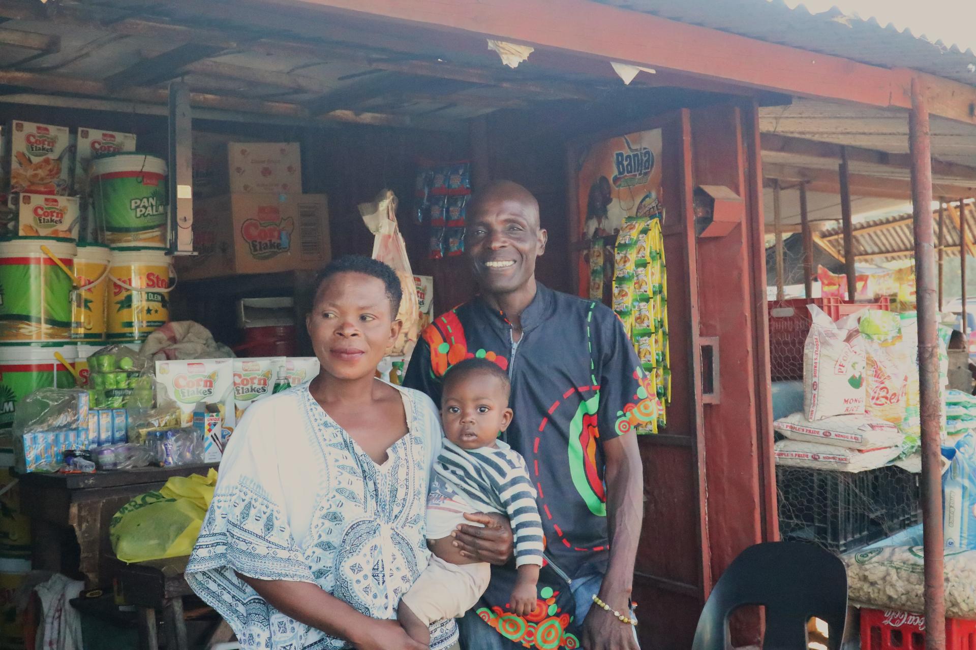 a woman and man standing in front of a store