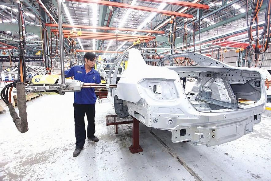 a man assembling different parts of a car