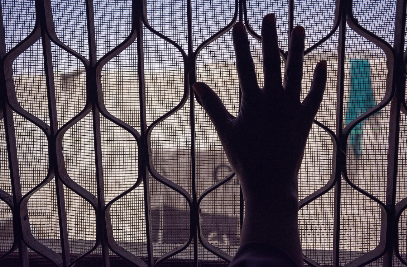 a person standing in front of a fence