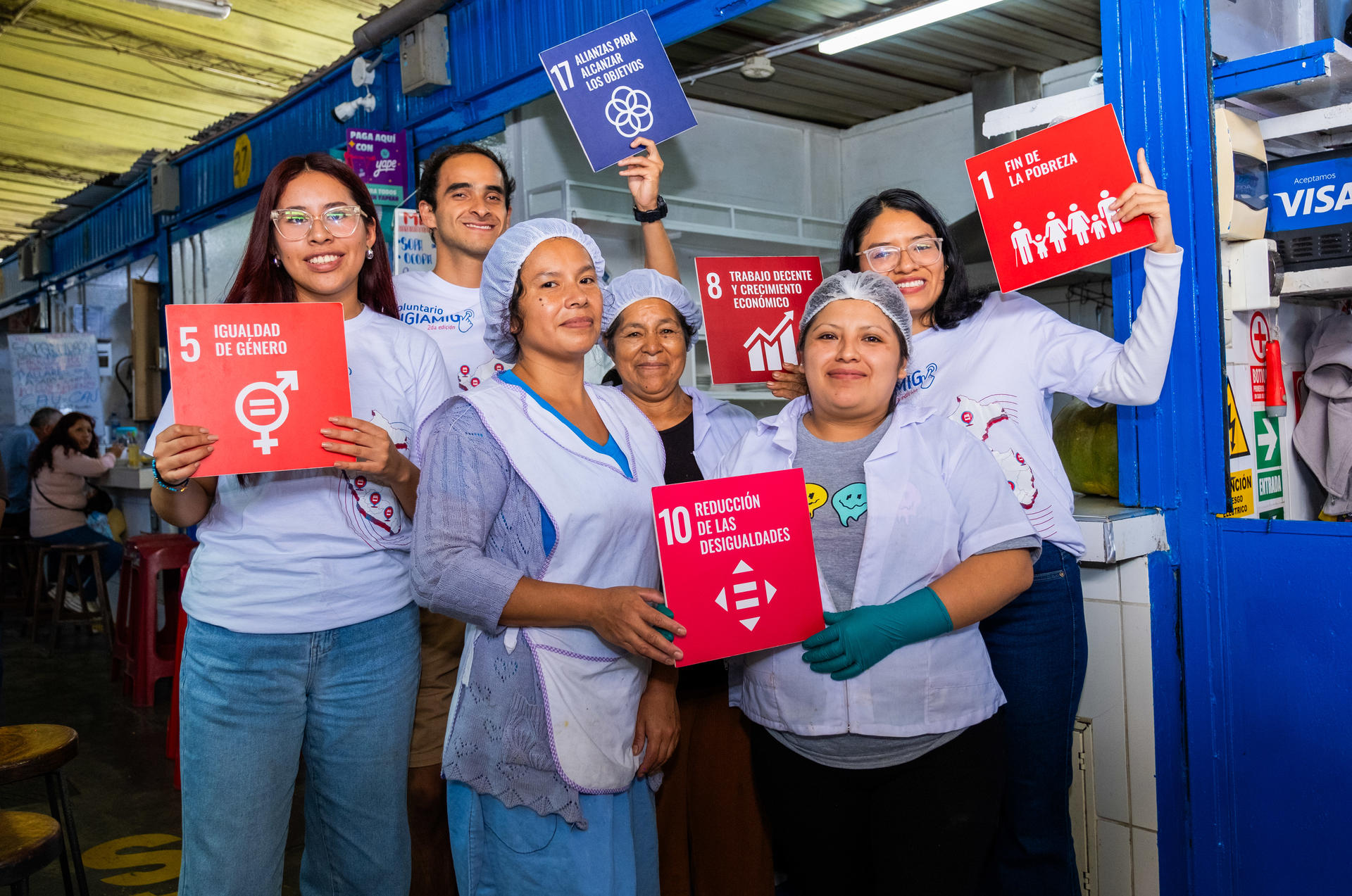 A group of women posing with different SDGs