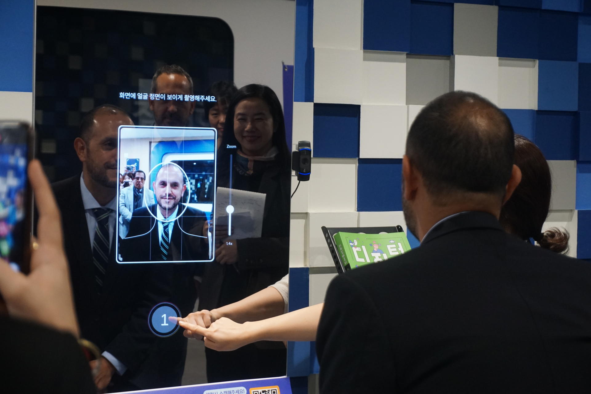 a group of people looking at a screen