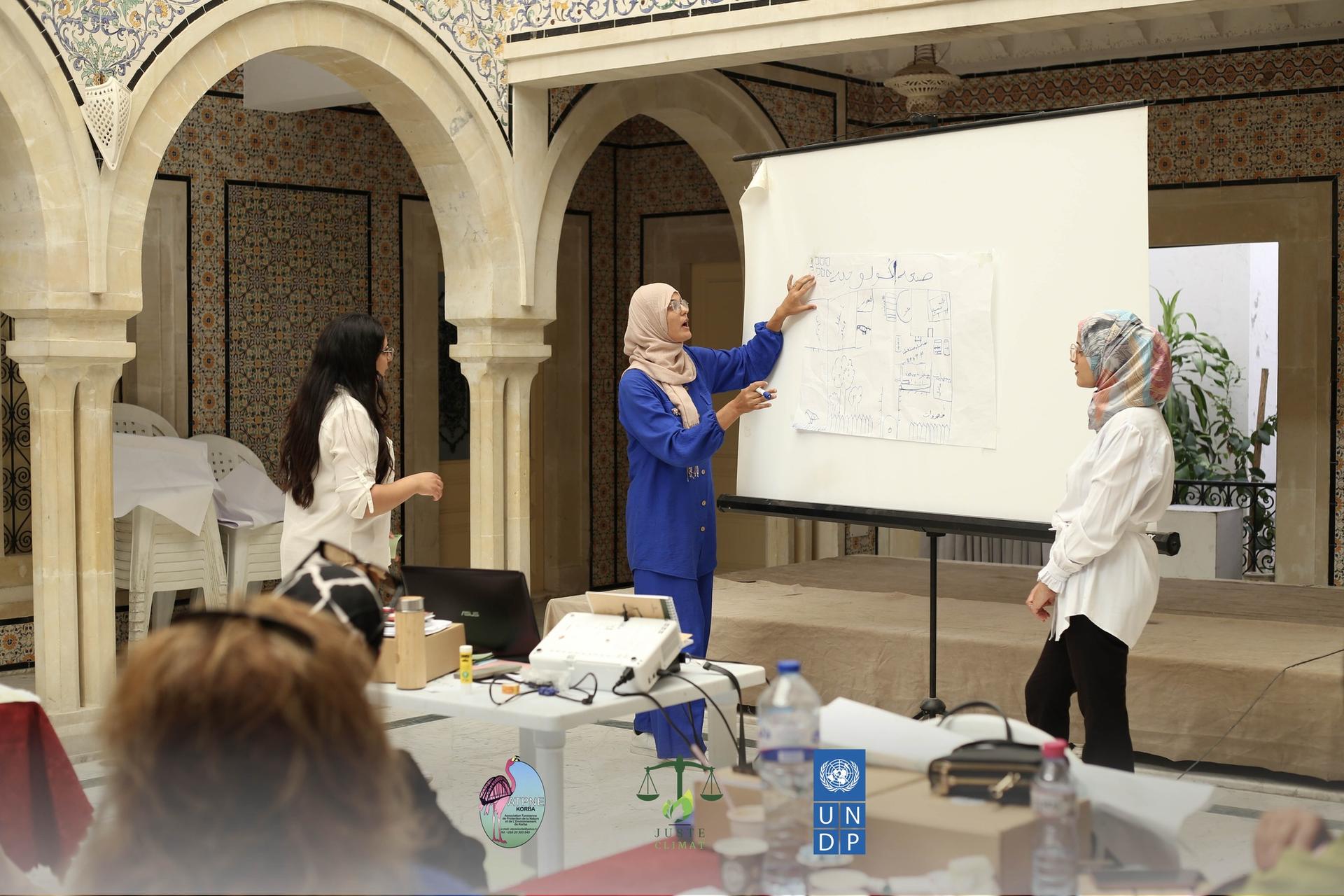 Three women are discussing a presentation in a beautifully decorated room.
