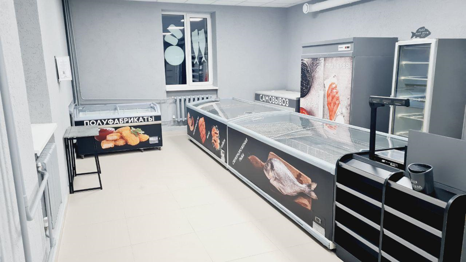A modern food display area with glass cases, a gray color scheme, and a clean layout.