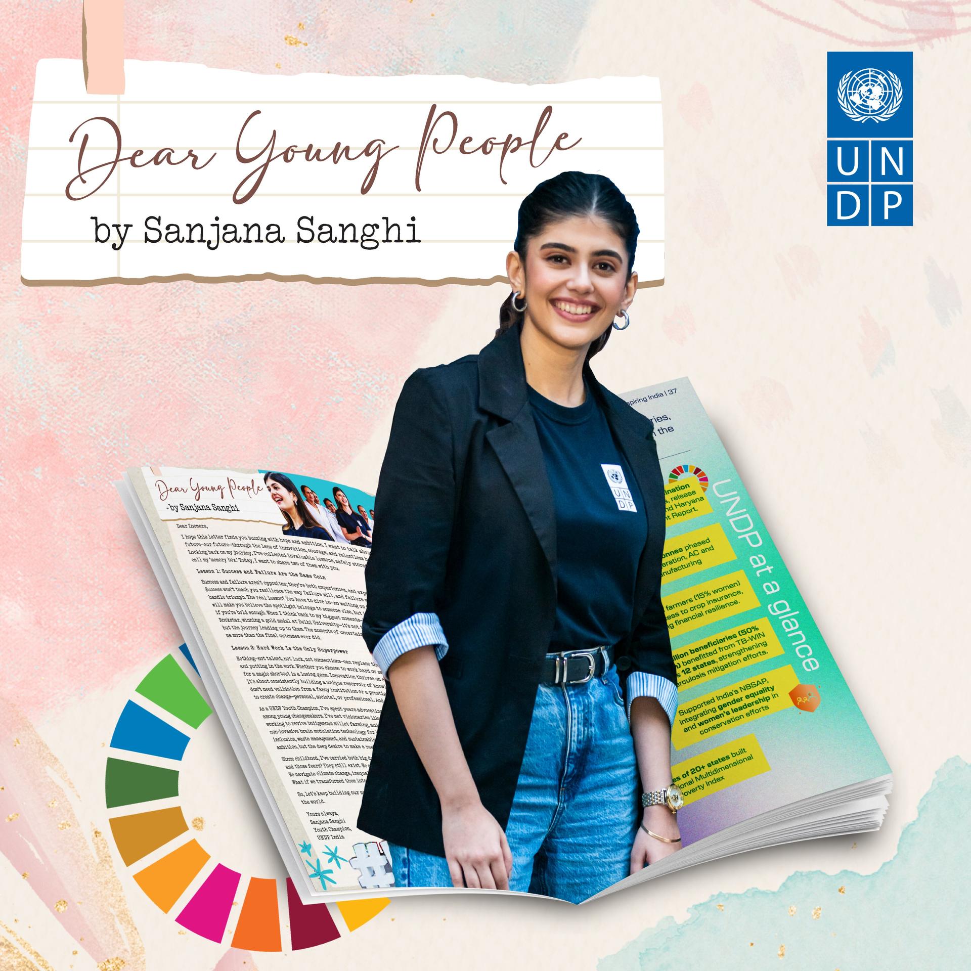 A young woman in a black blazer smiles, with a magazine open showcasing a colorful design.