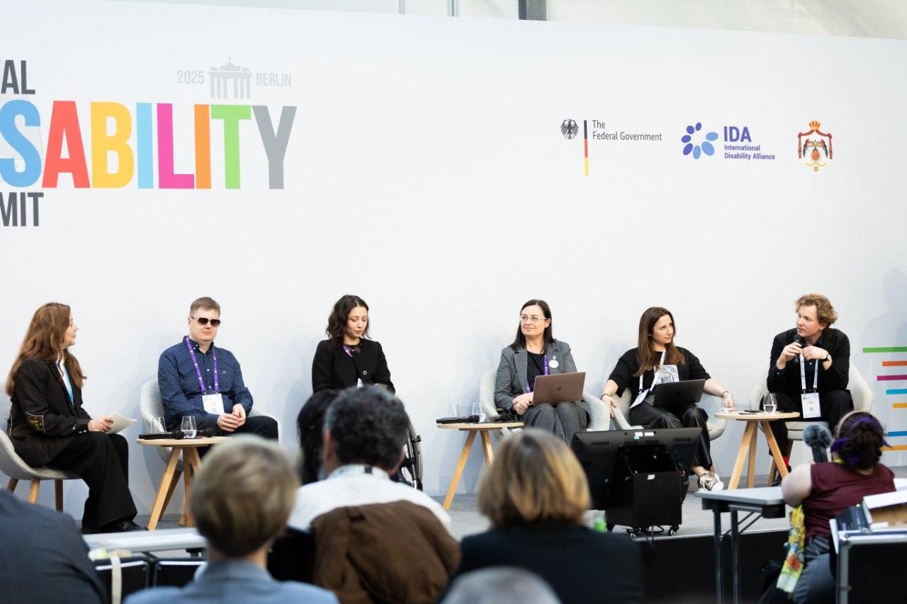 Panel discussion at the Global Disability Summit with six speakers and an audience.