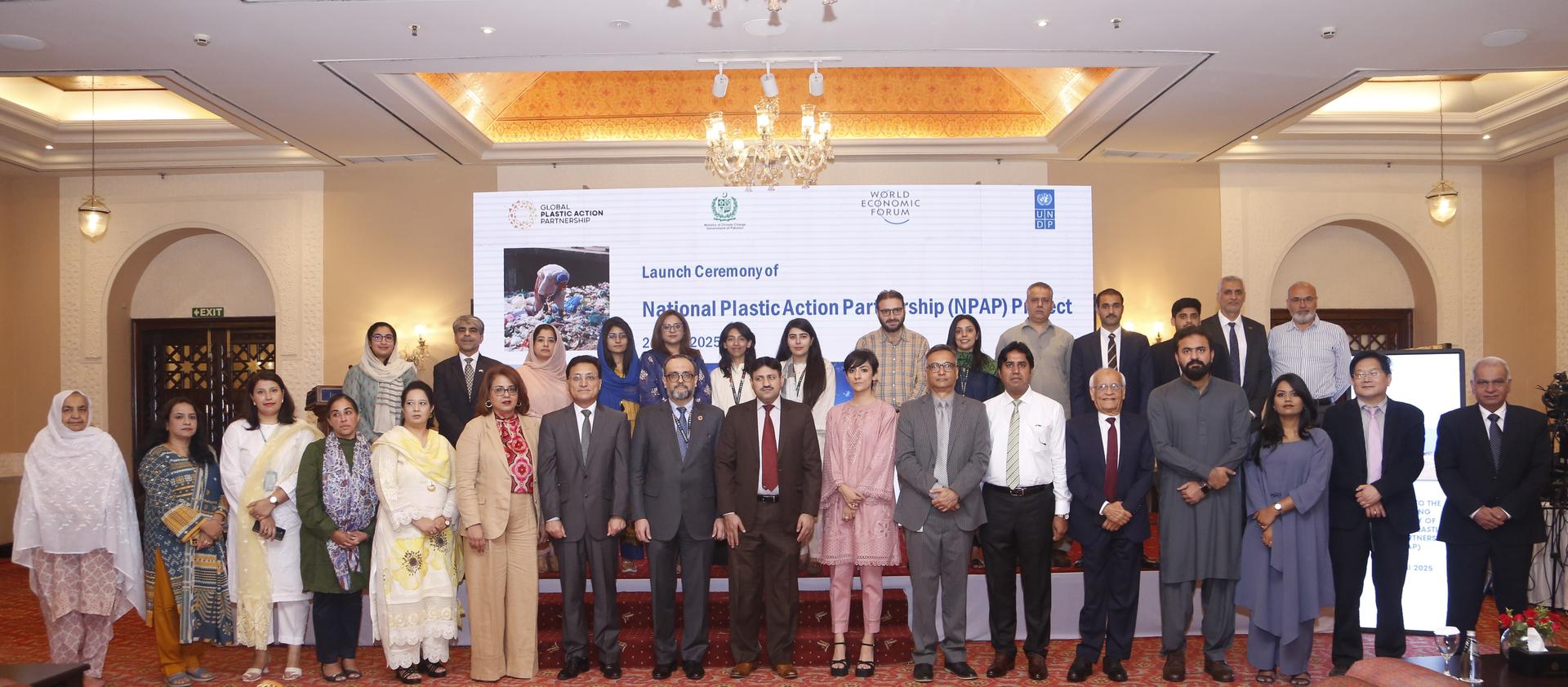Group of professionals posing together at an event in a formal setting.