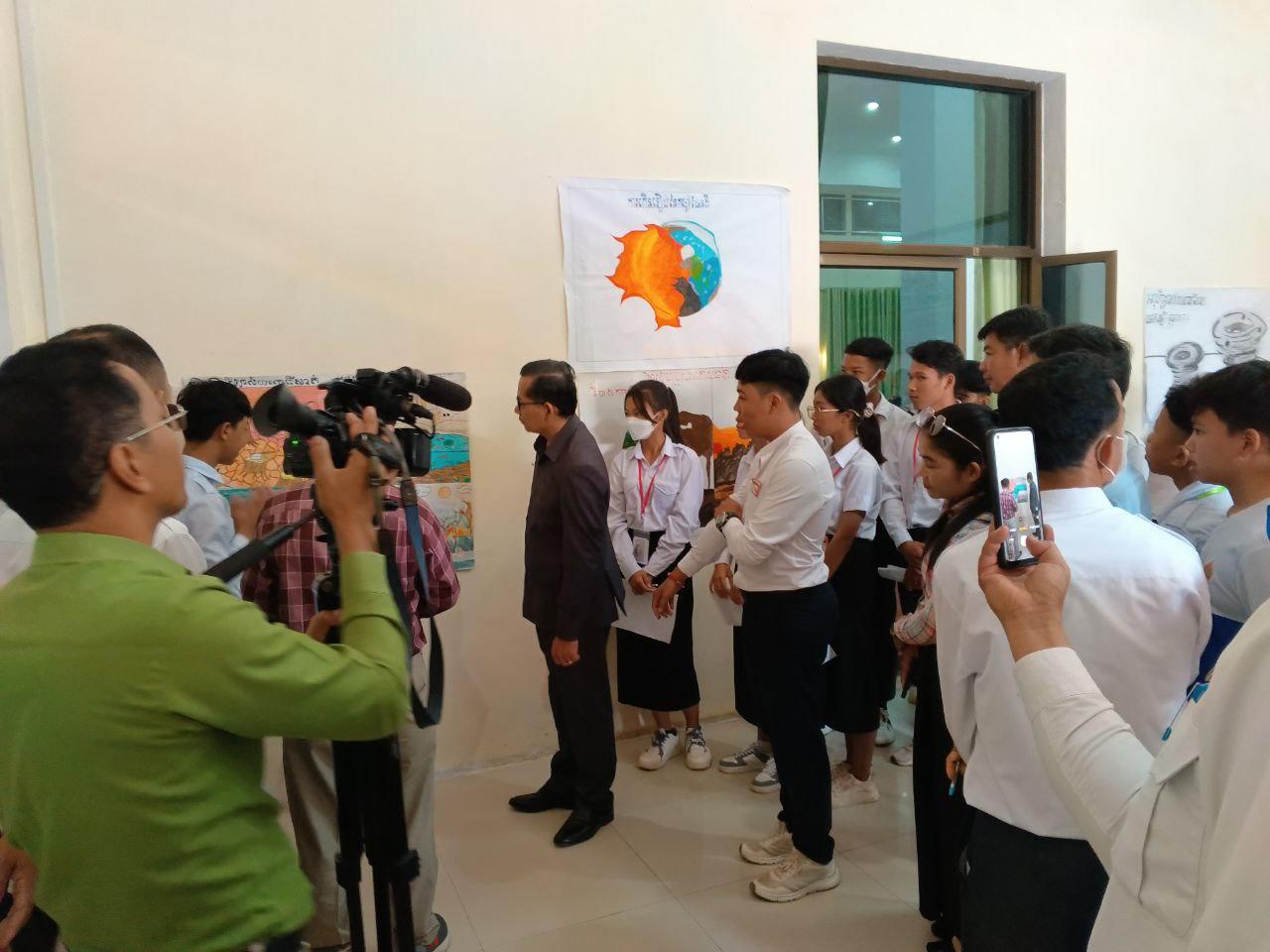 Students explore climate change solutions at a local school exhibition—part of ongoing efforts to raise awareness among youth and communities.
