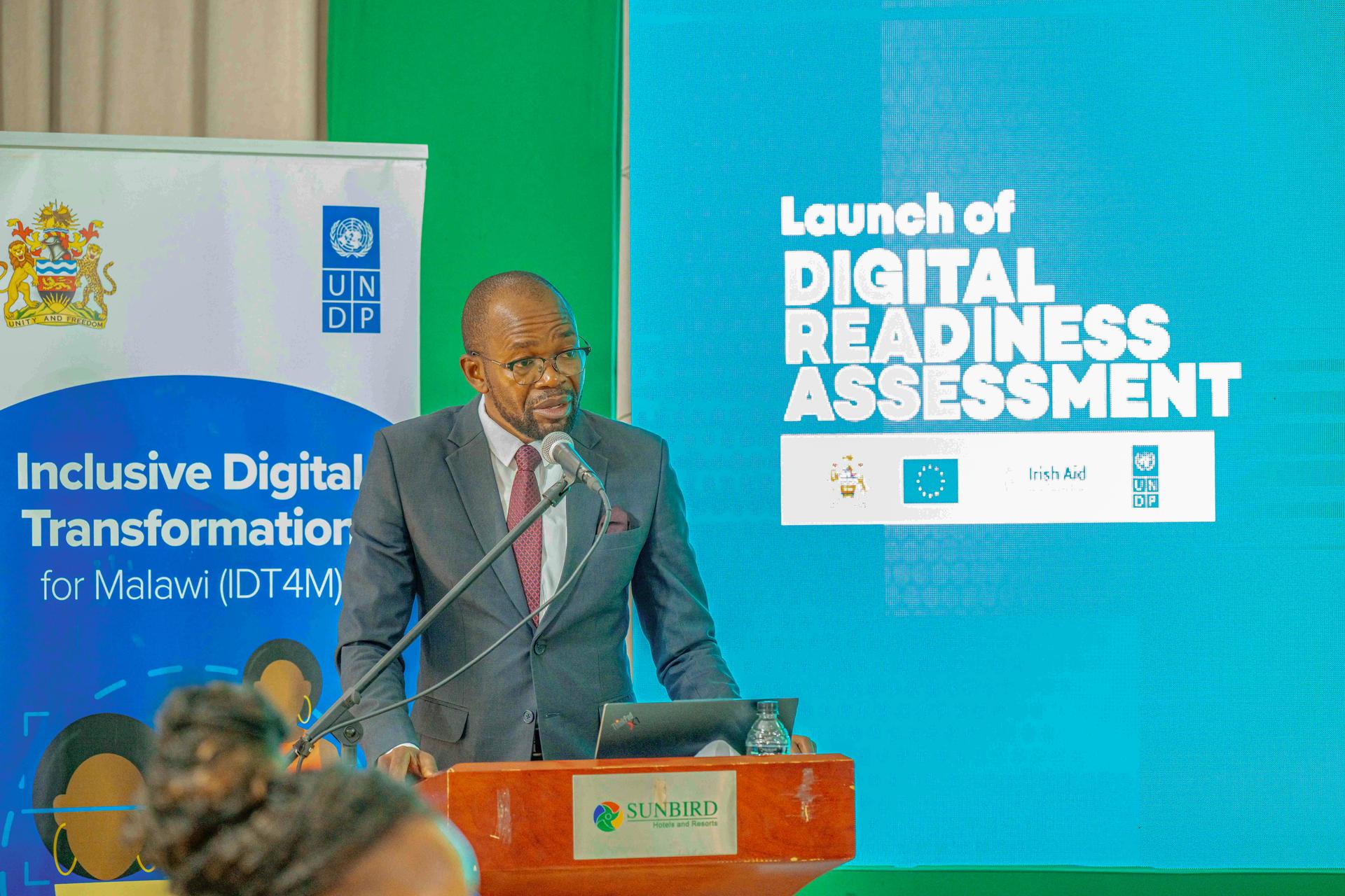 Man speaking at a podium during the launch of a digital readiness assessment event.