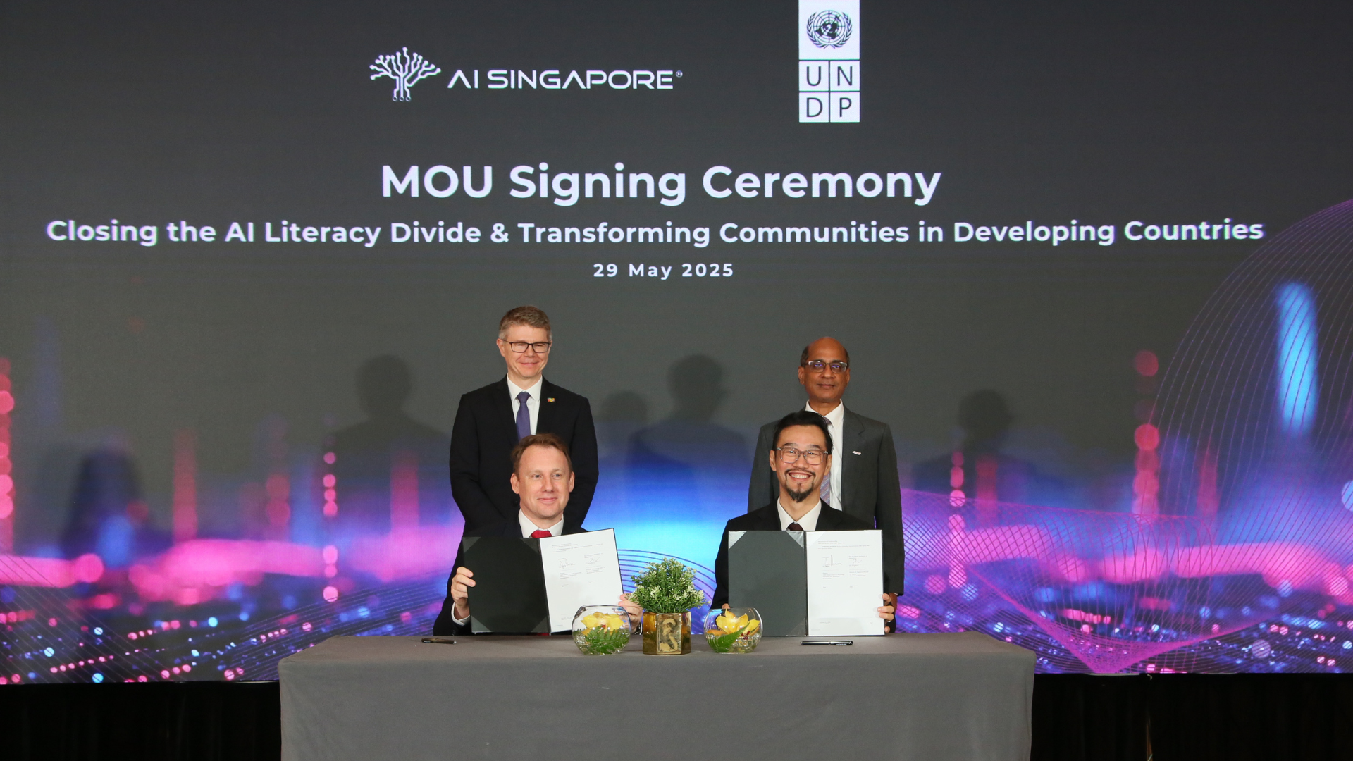 MOU signing ceremony with representatives from AI Singapore and UNDP, with the goal of working towards closing the AI literacy divide and transforming communities in developing countries.
