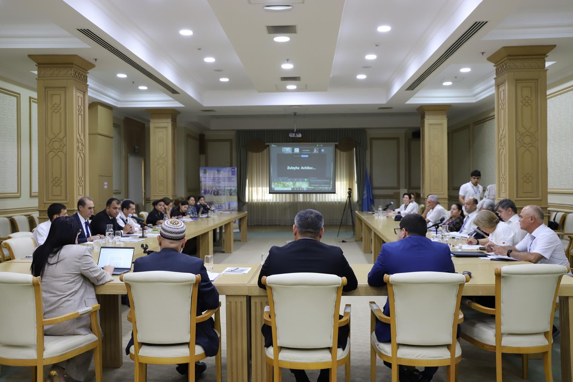 Conference room with seated participants facing a presentation screen.