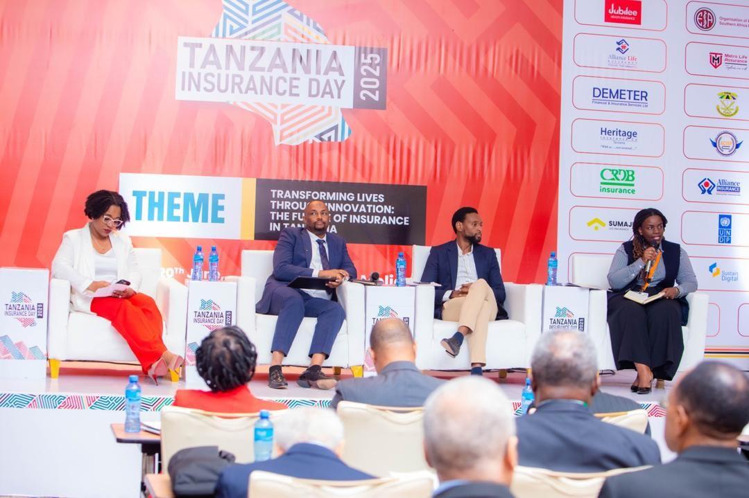 Panel discussion at Tanzania Insurance Day with four speakers on a stage and an audience.