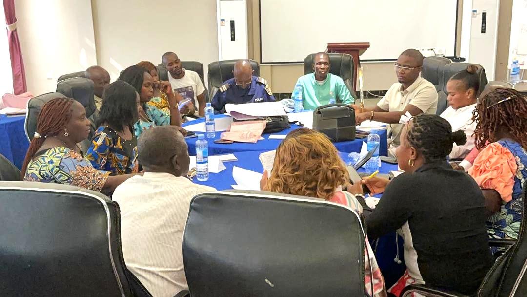 A group of people seated around a conference table engaged in discussion.