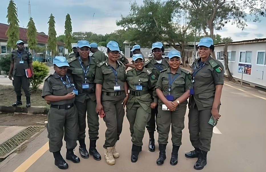 Photograph of uniformed officers in green uniforms posing together on a street.