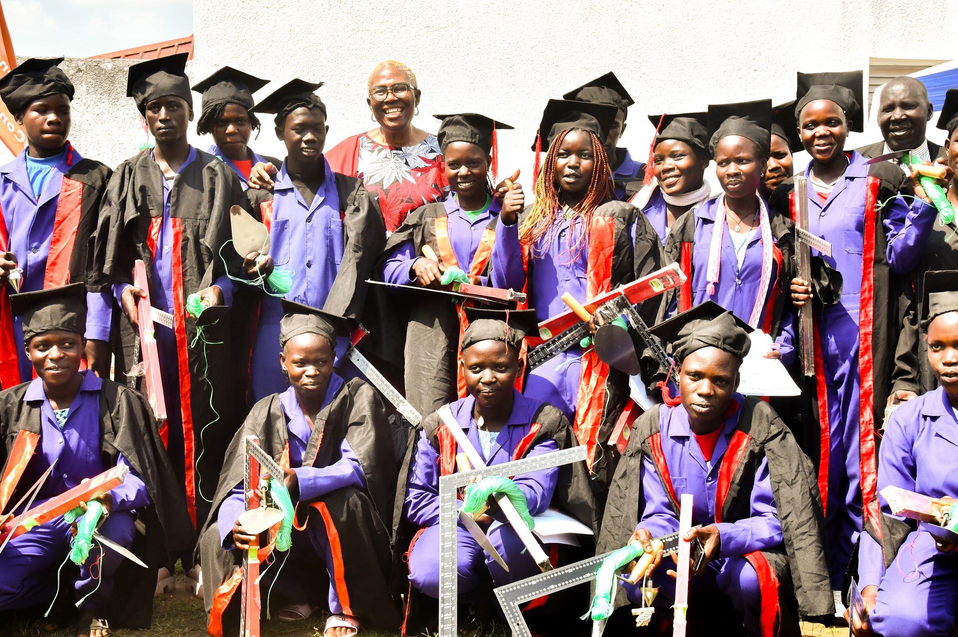 UNDP Resident Representative having a light moment with graduates in Tororo
