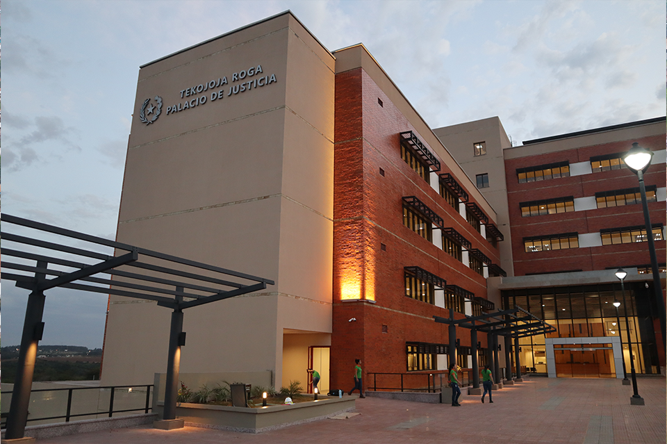 Modern multi-story building with brick and glass entrance at dusk.
