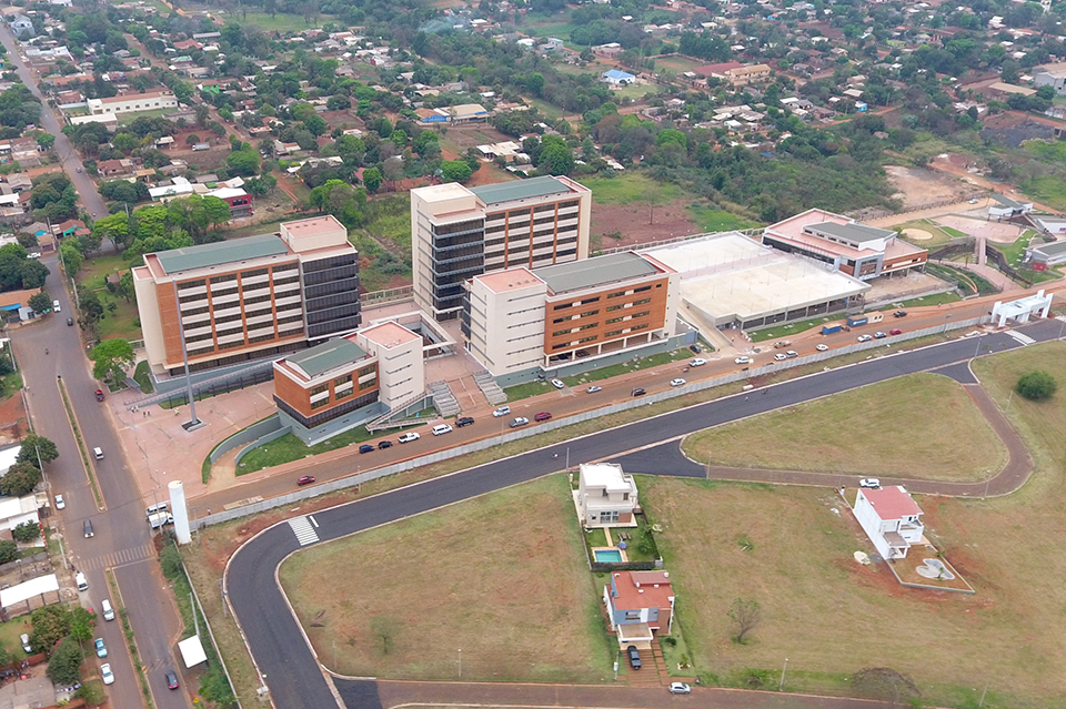 Aerial view of a campus with brick buildings, curved roads, and green lawns.