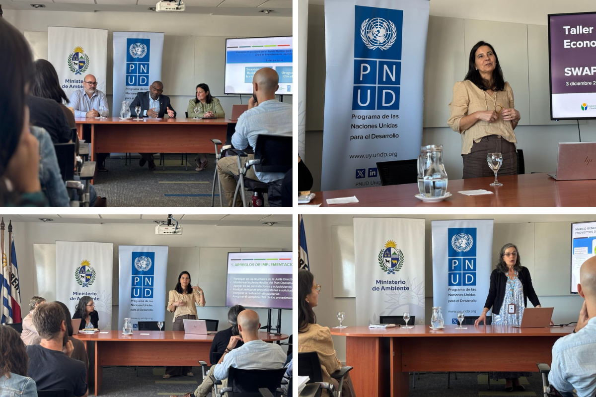 Conference room seminar: panelists and a speaker at the podium; banners and audience.