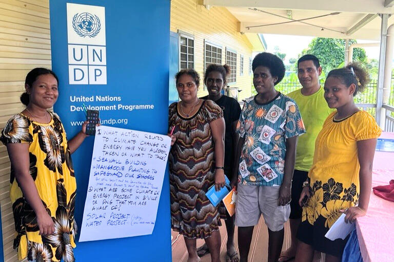 Lama Teffatu (left) and fellow youth participants take part in a group activity during the Movers Workshop on Climate Change and Renewable Energy session at the Innovation Hub in Buka