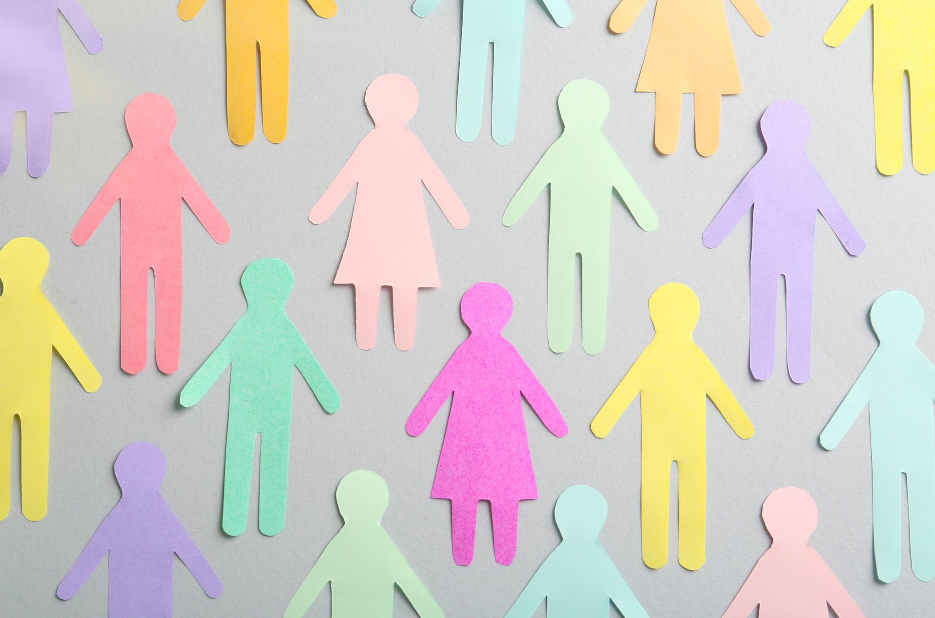 Graphic of pastel-colored paper cutout people arranged in a crowd.