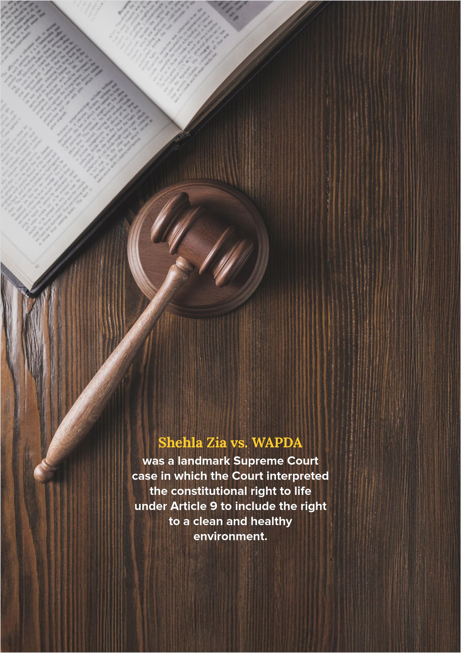 Photo of a gavel on a wooden table beside an open book.