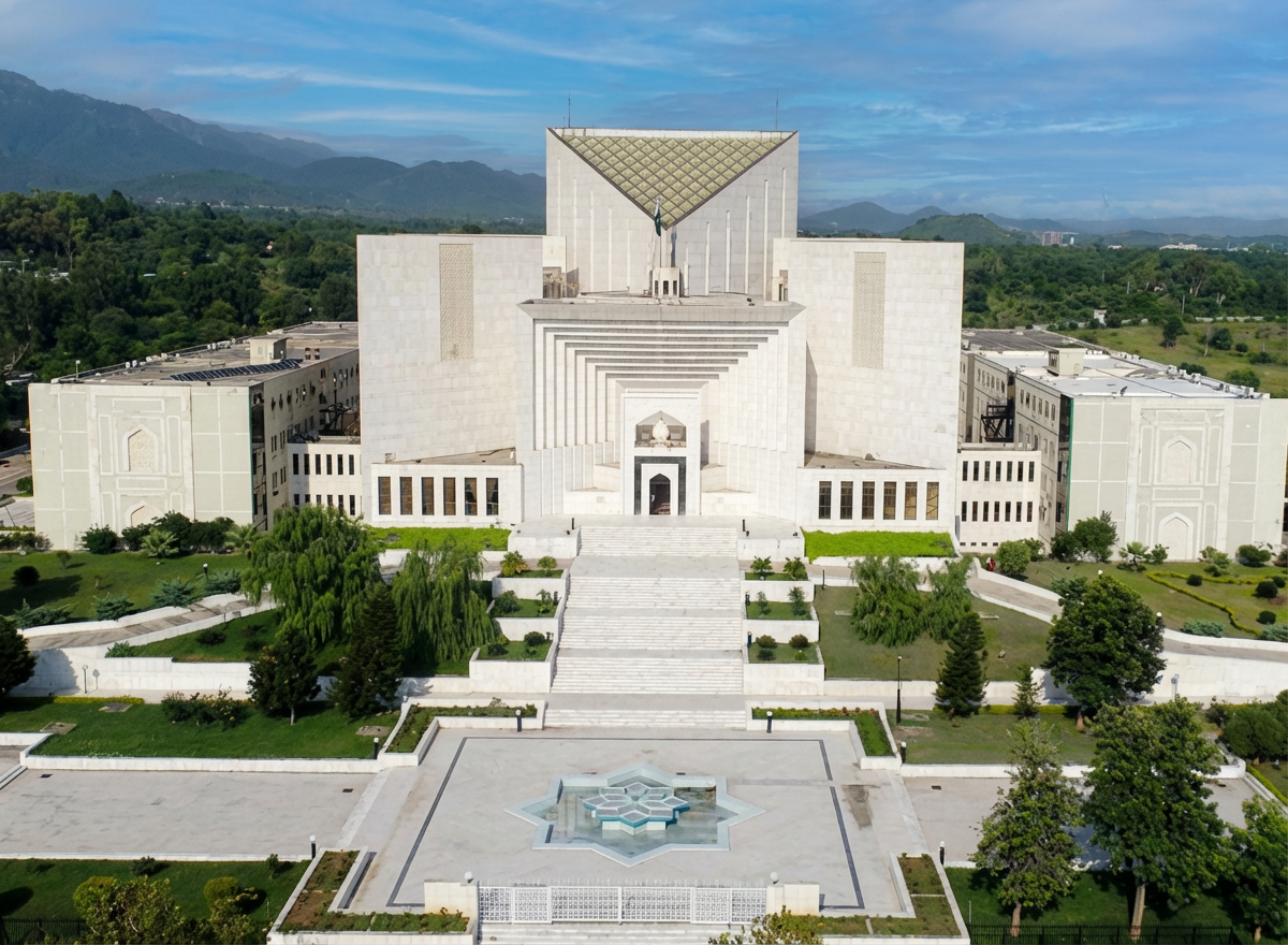 Large white monument-style building with central stairs, wings, and fountains on a manicured lawn.