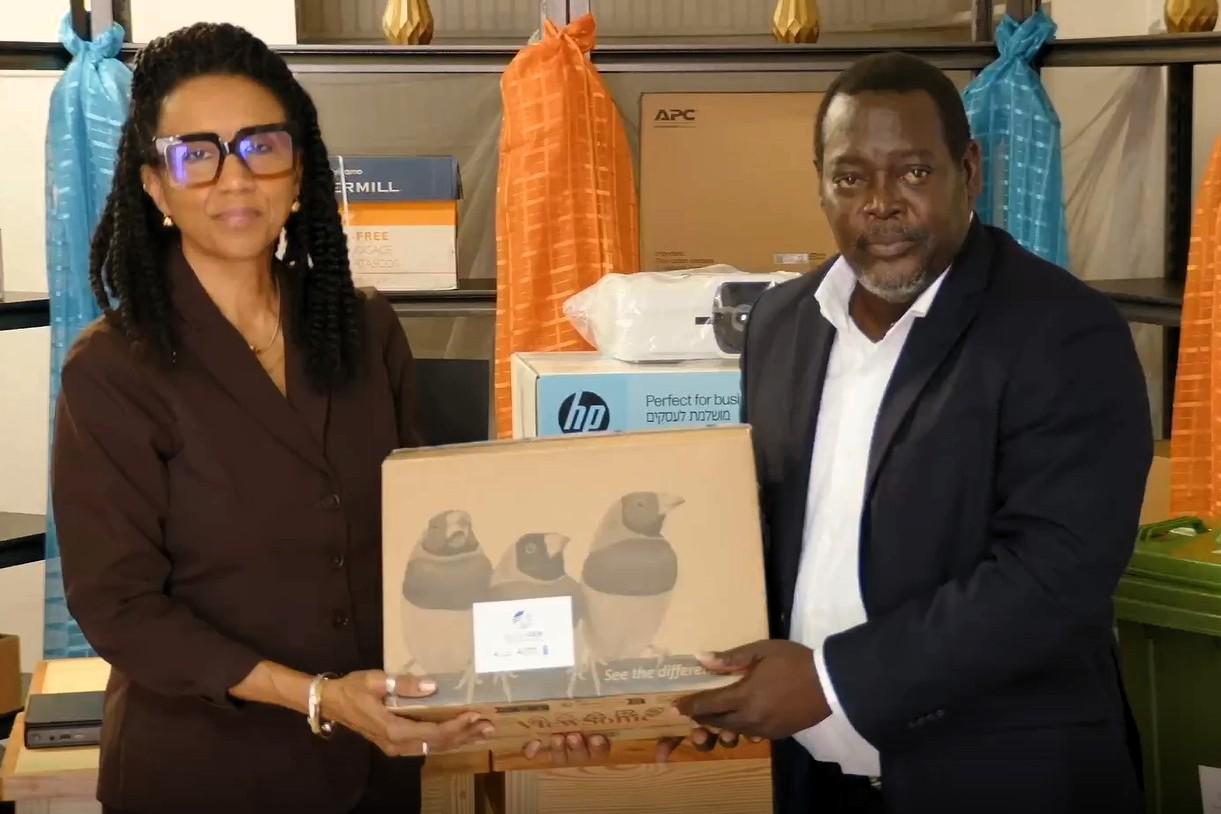 Two people pose holding a boxed product
